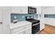 Modern kitchen with white cabinets, quartz countertops and stainless steel appliances at 205 Lakeside Pl, Canton, GA 30114