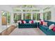 Bright sunroom features two teal sofas and large windows at 205 Lakeside Pl, Canton, GA 30114