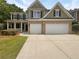 Two-story house with double garage and landscaping at 856 Win West Pointe, Auburn, GA 30011