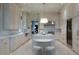 Bright kitchen featuring white cabinets, marble counters, and island seating at 2440 Peachtree Nw Rd # 1, Atlanta, GA 30305