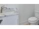 Simple bathroom with white vanity and marble countertop at 1284 Six Sisters St, Dacula, GA 30019