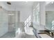 Bathroom with walk-in shower, soaking tub, and dark countertop at 1284 Six Sisters St, Dacula, GA 30019