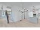 Open dining room with hardwood floors and chandelier at 1284 Six Sisters St, Dacula, GA 30019