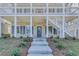 Front porch with brick columns and gray shutters at 1284 Six Sisters St, Dacula, GA 30019