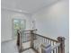 Upper hallway with wood railing and carpet flooring at 1284 Six Sisters St, Dacula, GA 30019