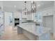 Modern kitchen with white cabinets, marble countertops, and an island at 1284 Six Sisters St, Dacula, GA 30019