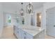 Modern kitchen with white cabinets, marble countertops, and an island at 1284 Six Sisters St, Dacula, GA 30019