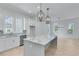 Modern kitchen with white cabinets, marble countertops, and an island at 1284 Six Sisters St, Dacula, GA 30019
