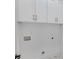 Laundry closet with white cabinets and shelving at 1284 Six Sisters St, Dacula, GA 30019