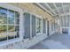 Side porch with gray shutters and brick accents at 1284 Six Sisters St, Dacula, GA 30019