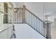 Elegant staircase with metal balusters and wooden handrail at 1284 Six Sisters St, Dacula, GA 30019