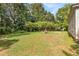 Spacious backyard with lush greenery and wooden benches at 4115 Hicks Rd, Austell, GA 30106
