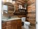 Bathroom with wood-paneled walls and granite countertop at 14 Lake Point Se Dr, Cartersville, GA 30121