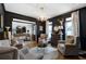 Elegant living room with dark walls, plush seating, and a statement chandelier at 14 Lake Point Se Dr, Cartersville, GA 30121