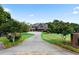 Long driveway leading to a two-story home with landscaping and brick pillars at 14 Lake Point Se Dr, Cartersville, GA 30121