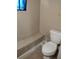 Basement bathroom with toilet and small window at 1005 Ashby Ter, Atlanta, GA 30314