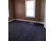 Simple bedroom with dark grey carpet and neutral walls at 1005 Ashby Ter, Atlanta, GA 30314
