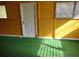 Large bonus room with green carpet, an exterior door and painted yellow walls at 1005 Ashby Ter, Atlanta, GA 30314