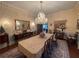 Formal dining room with a large table, crystal chandelier, and decorative wall art at 3355 Smithtown Rd, Suwanee, GA 30024