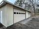 Tan metal three-car garage with extra storage at 3355 Smithtown Rd, Suwanee, GA 30024