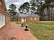 Brick patio with planters next to brick home and outbuilding at 3355 Smithtown Rd, Suwanee, GA 30024