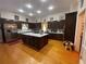 Large kitchen featuring an island, stainless steel appliances, and dark wood cabinets at 3355 Smithtown Rd, Suwanee, GA 30024