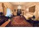 Spacious living room featuring hardwood floors, ornate furnishings, and a large tapestry at 3355 Smithtown Rd, Suwanee, GA 30024