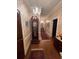 Elegant hallway with hardwood floors, antique clock, and ornate wallpaper at 3355 Smithtown Rd, Suwanee, GA 30024