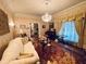 Bright living room with hardwood floors, comfortable seating, and a charming window treatment at 3355 Smithtown Rd, Suwanee, GA 30024