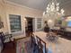 Formal dining room with a large table, built-in shelving, and crystal chandelier at 3355 Smithtown Rd, Suwanee, GA 30024