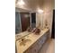 Double vanity bathroom with beige countertop and mirror at 3355 Smithtown Rd, Suwanee, GA 30024