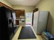 Kitchen area with wood cabinets, stove, and two refrigerators at 3355 Smithtown Rd, Suwanee, GA 30024