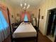 Bedroom with four-poster bed and floral wallpaper at 3355 Smithtown Rd, Suwanee, GA 30024