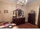 Bedroom with antique dresser and charming wallpaper at 3355 Smithtown Rd, Suwanee, GA 30024