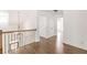 Upstairs hallway with hardwood floors and elegant iron railing at 1410 Eastland Se Rd, Atlanta, GA 30316