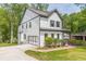 Side view of a two-story house showcasing its white siding and landscaping at 1410 Eastland Se Rd, Atlanta, GA 30316