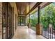 Covered balcony with brick flooring and wrought iron railings at 56 Mount Paran Rd, Atlanta, GA 30327