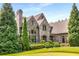 Stone and brick home with lush landscaping, showcasing the side yard at 56 Mount Paran Rd, Atlanta, GA 30327