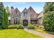Stone and brick exterior of a charming two-story home with manicured landscaping at 56 Mount Paran Rd, Atlanta, GA 30327