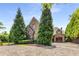 Brick and stone home with a large paved driveway and gated entrance at 56 Mount Paran Rd, Atlanta, GA 30327