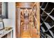 Walk-in wine cellar with rustic wood shelving and arched doorway at 56 Mount Paran Rd, Atlanta, GA 30327