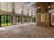Covered patio with flagstone flooring, arched windows, and a fireplace at 56 Mount Paran Rd, Atlanta, GA 30327