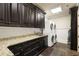 Laundry room with granite countertops and matching cabinetry at 56 Mount Paran Rd, Atlanta, GA 30327