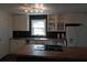 Kitchen with white cabinets, butcher block island, and dark backsplash at 598 Mccurdy Rd, Villa Rica, GA 30180