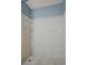 Stand-up shower with light beige tile and metal shelving at 5187 Vivid Dr, Stone Mountain, GA 30087