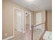 Upstairs hallway with doors to bedrooms and carpet flooring at 5187 Vivid Dr, Stone Mountain, GA 30087