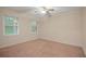 Bright bedroom with ceiling fan, carpet, and large windows at 5187 Vivid Dr, Stone Mountain, GA 30087