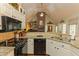 Bright kitchen with granite countertops, white cabinets, and stainless steel appliances at 6425 Mixon Rd, Chattahoochee Hills, GA 30268