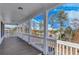 Covered balcony with wood floor and scenic wooded views at 1264 Six Sisters St, Dacula, GA 30019