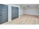 Spacious basement with wood floors, ceiling fan, and multiple doors for storage at 1264 Six Sisters St, Dacula, GA 30019